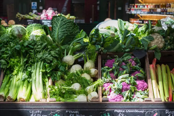 Photo of A variety of vegetables displayed at a produce stall in Borough Market in London