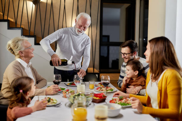 istock Happy multi-generation family enjoying during a meal at dining table. 1425451916