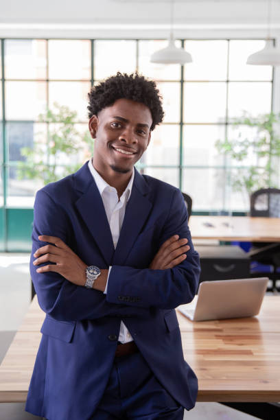 istock African-American man standing with folded arms in office 1425453635