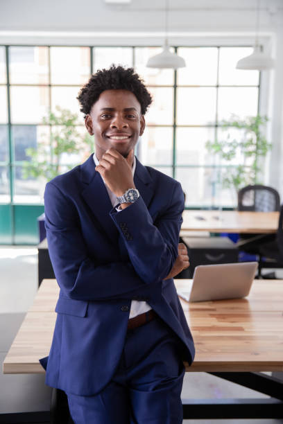 istock Happy male employee standing in office and smiling 1425453676