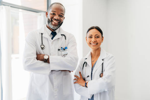 Doctor, healthcare and medical man and woman with smile and confident leadership at hospital. Portrait of happy team, trust and success medic professional worker or employee for empowerment in clinic stock photo