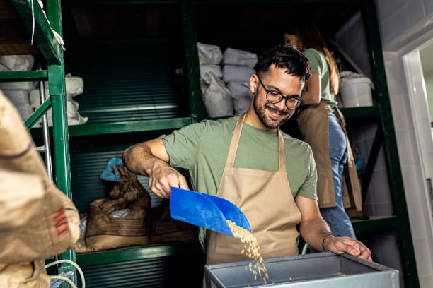 istock Male brewer grinding barley in brewery warehouse. 1425457641
