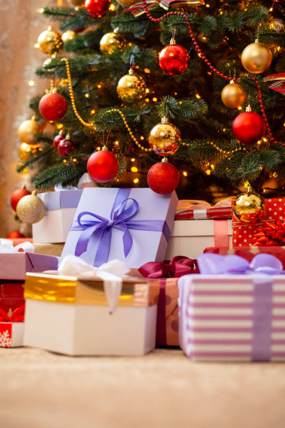 istock Colourful christmas presents under christmas tree on flour 1425462078