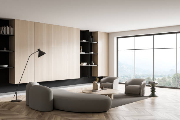 istock Light relax room interior with couch and armchairs, shelf and panoramic window 1425462545