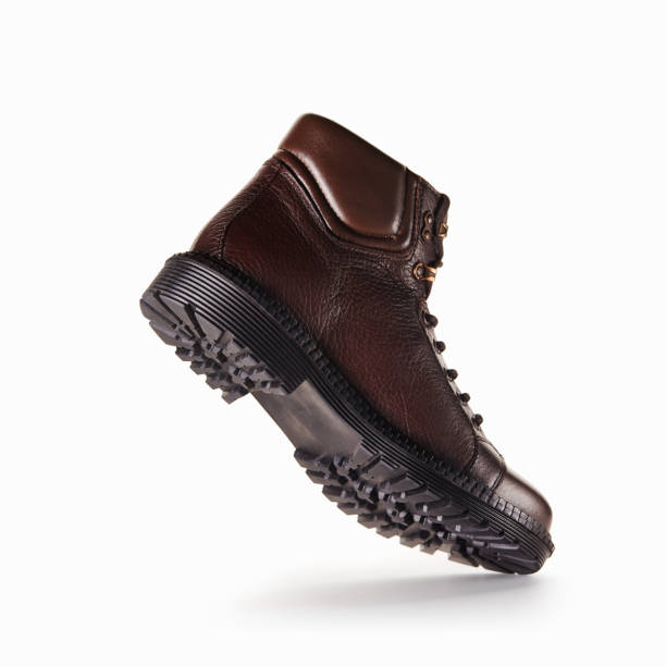 Brown male boot on white background seen from low angle