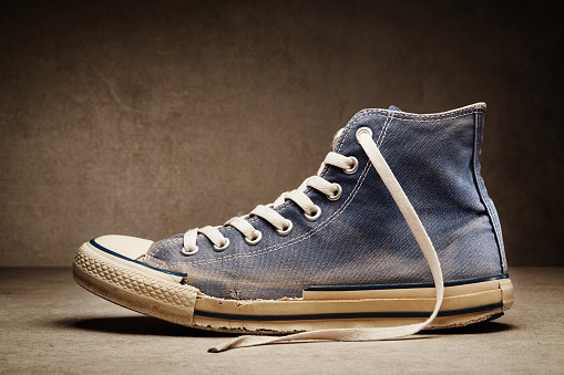 Old, stinky, torn, dirty canvas sneaker