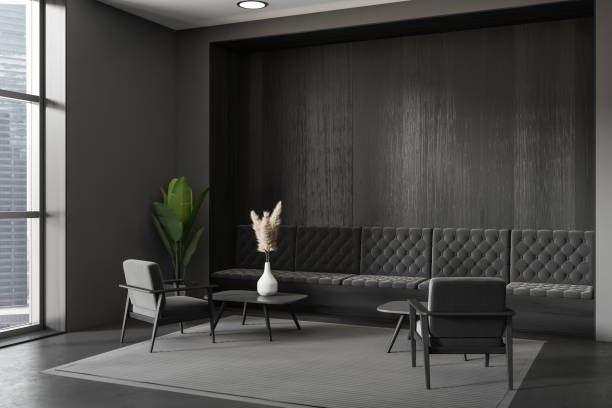 istock Dark living room interior with couch and armchairs, panoramic window. Empty wall 1425466352
