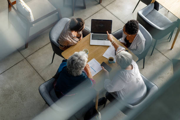 istock Executive explaining strategies over laptop to coworkers in office 1425466567