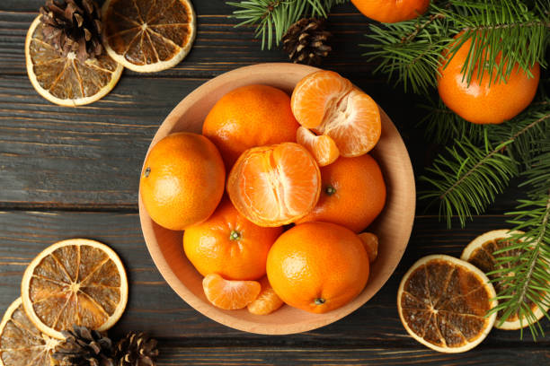 istock Christmas concept with mandarins on rustic wooden table 1425472522