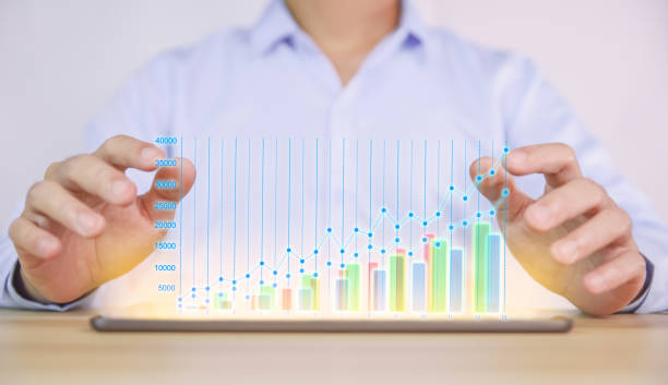 istock businessman using a tablet to plan a strategy that shows a positive digital technology graph chart. The concept is growing stocks, investing, stock marketing, and success. 1425472594
