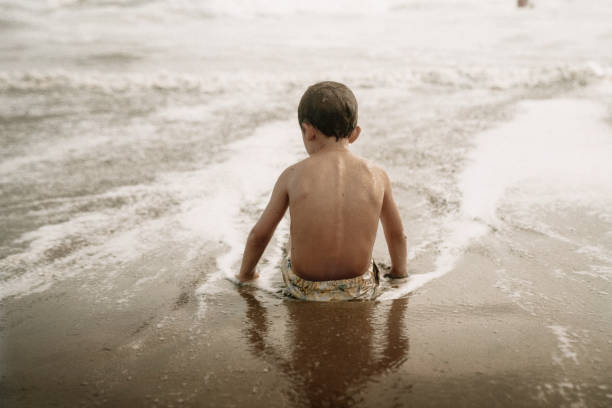 istock Kids playing at the beach 1425474665