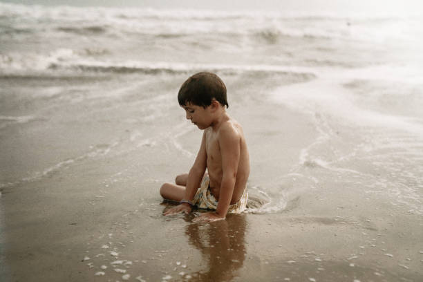 istock Kids playing at the beach 1425474701