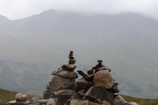 2 piles of stones on a mountain in Scotland.