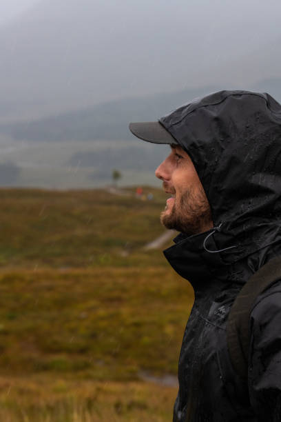 istock happy hiker in Scotland. Raining. Raincoat. 1425475457