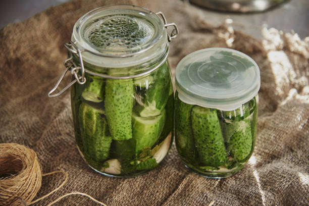 istock Salted, pickled cucumbers in a jar on an old wooden table 1425477301