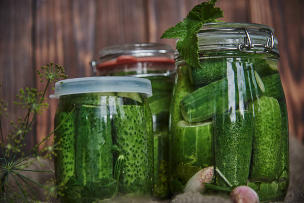 istock Salted, pickled cucumbers in a jar on an old wooden table 1425477326