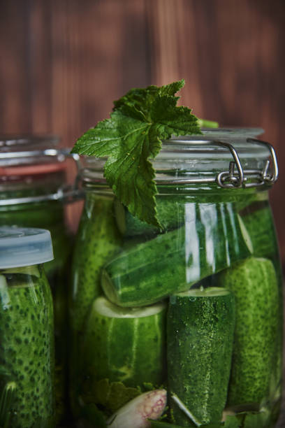 istock Salted, pickled cucumbers in a jar on an old wooden table 1425477328