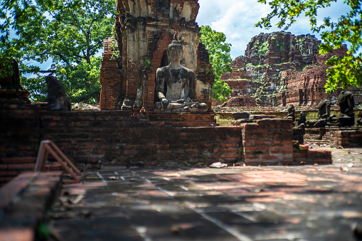 An ancient Buddha sculpture was damaged at an old temple at Wat Phra Mahathat, Ayutthaya, Thailand