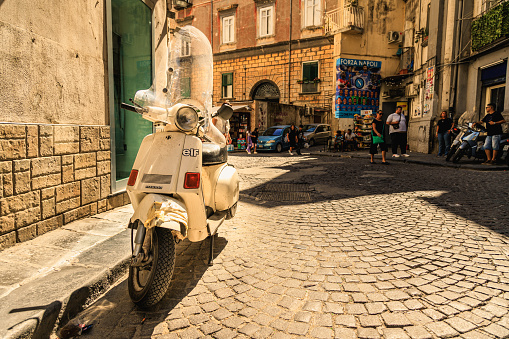 Vintage scooter in old Napoli streets, Italia. Naples, Italy - September 13, 2022