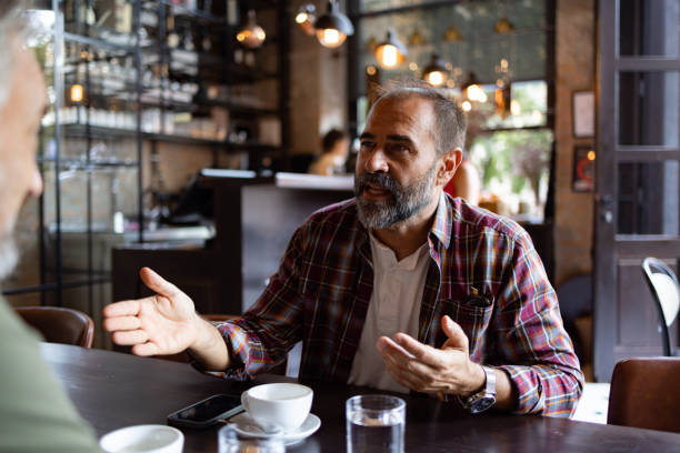 istock Two friends meeting for a cup of coffee 1425483732