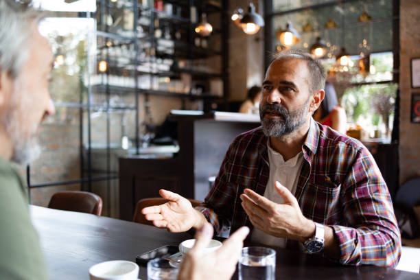 istock Two friends meeting for a cup of coffee 1425483767