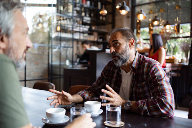 istock Two friends meeting for a cup of coffee 1425483848