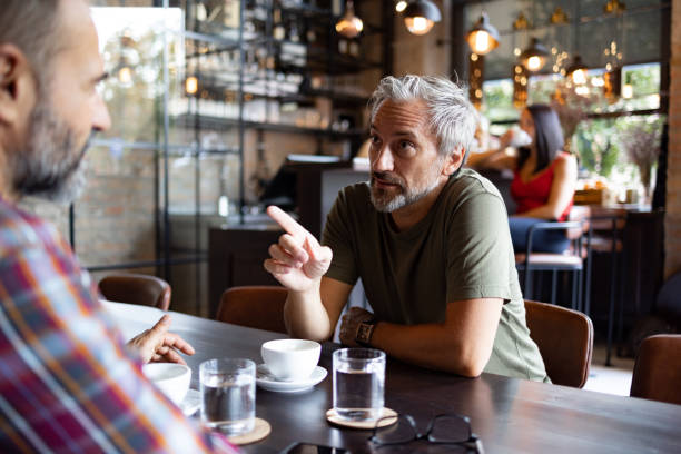 istock Two friends meeting for a cup of coffee 1425483894
