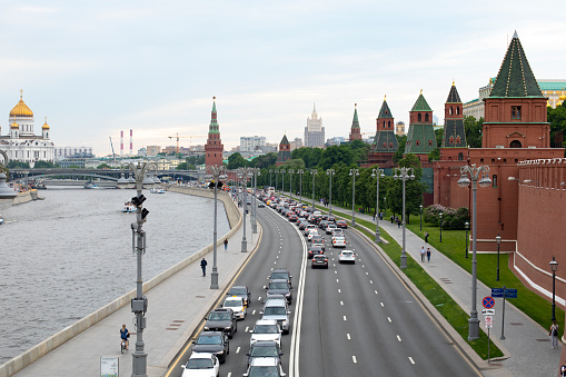 Moscow, Russia - May 28, 2021: Kremlin embankment on the banks of the Moskva river, red brick Kremlin wall with towers, beautiful view of Moscow