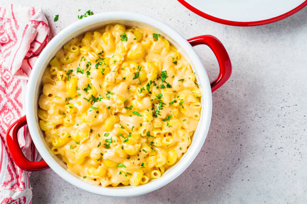 Mac and cheese in red pot. Traditional American food. stock photo