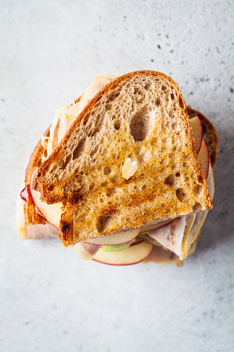 Turkey and apple sandwich, gray background, top view. Thanksgiving leftovers concept.