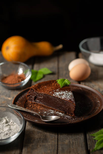 istock Chocolate pumpkin pie on a wooden background. Cooking. 1425490989