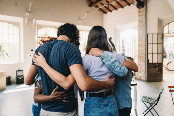 istock People embracing together in their office 1425491772