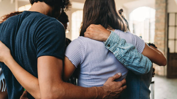 People embracing together in their office