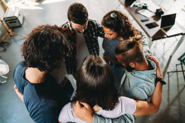 istock People embracing together in their office 1425491791