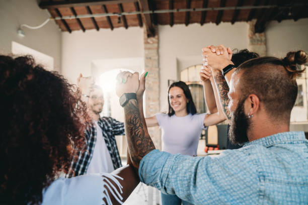 istock Group of people holding hands together 1425491835
