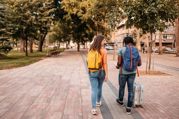 istock Happy tourist couple using map in foreign city 1425491851