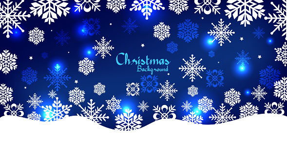 White colored snow and snowflakes at the bottom of a dark blue horizontal Christmas background