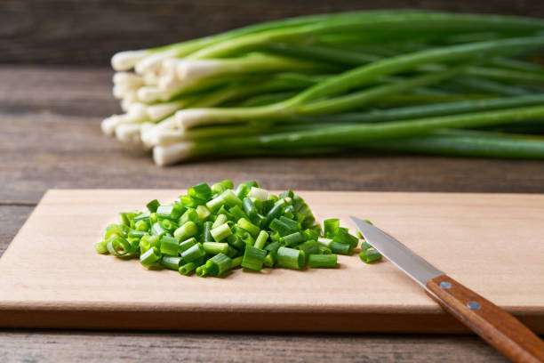 istock Fresh chopped green onion on a cutting board, selective focus. 1425493675