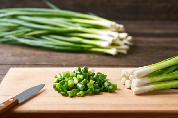istock Fresh chopped green onion on a cutting board, selective focus. 1425493697