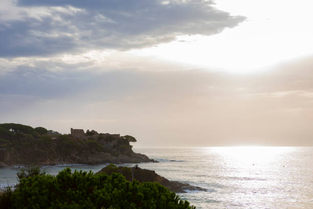 Cala Fosca in Costa Brava, sunrise between the clouds at september