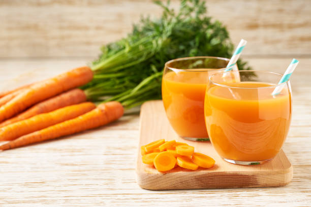 istock Fresh carrot smoothies and vegetables on a wooden table,close-up. 1425499792