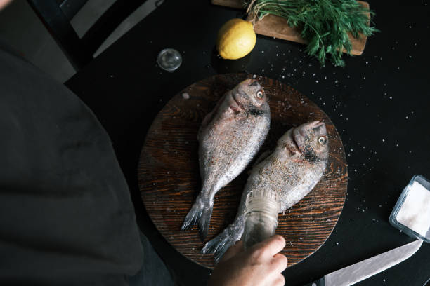 istock Preparing fresh sea bream for frying 1425501252