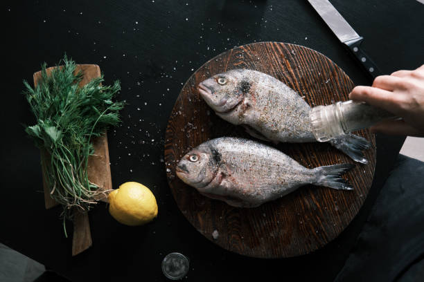istock Preparing fresh sea bream for frying 1425501305