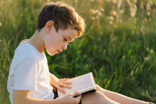 istock Christian boy holds bible in her hands 1425501371