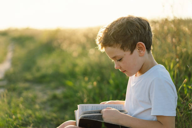 istock Christian boy holds bible in her hands 1425501435