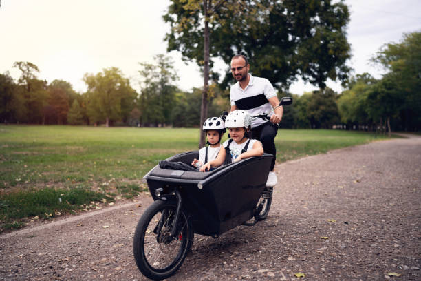 istock Father riding his daughters in a cargo bike 1425501548