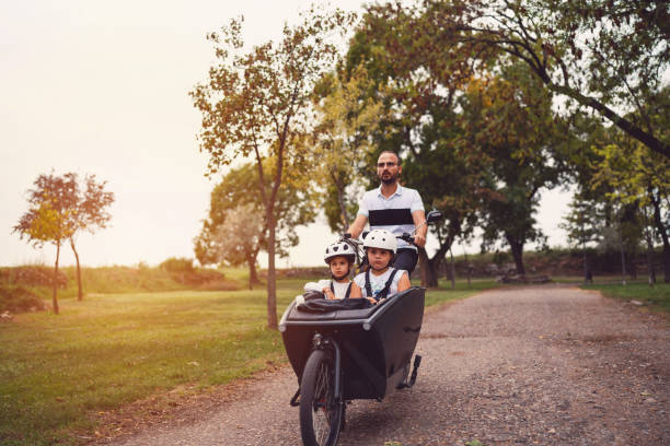 istock Father riding his daughters in a cargo bike 1425503768