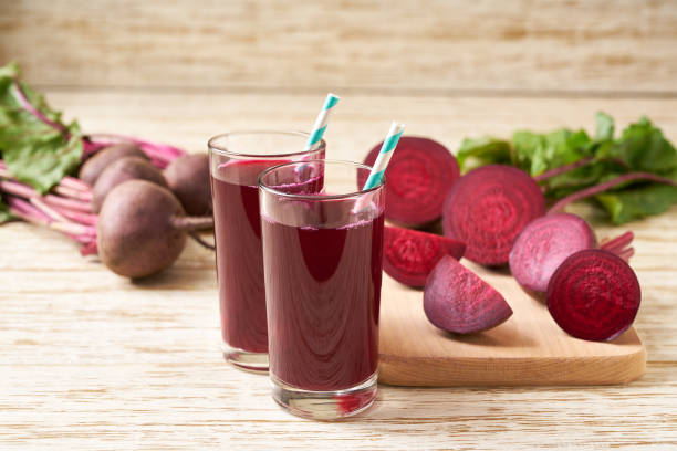 istock Fresh beet juice in glasses on a  white wooden table, selective focus. 1425504078