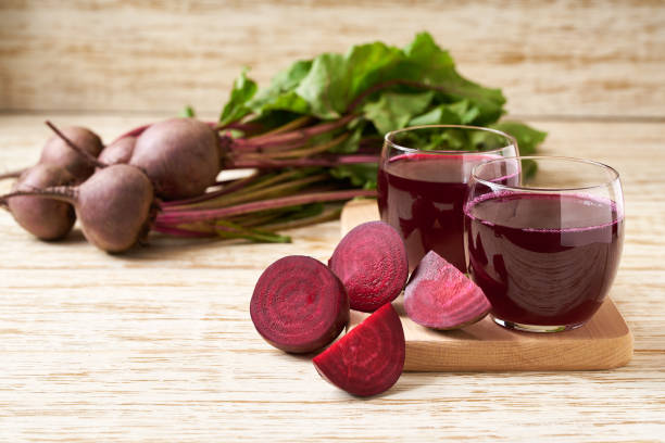 istock Fresh beetroot smoothies and vegetables on a wooden table. 1425504088
