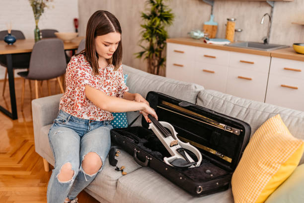 istock Young Woman Taking Out Her Violin From The Case 1425505409